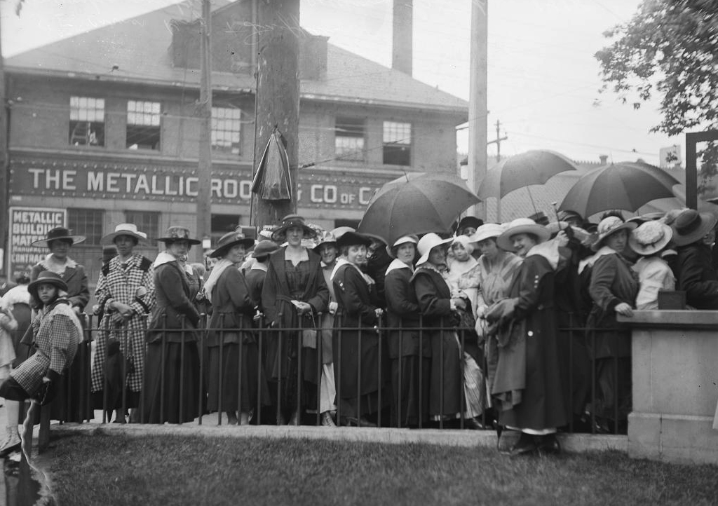 1918 - Munitions workers lining up for the last day of pay at King St W and Dufferin St, southeast corner