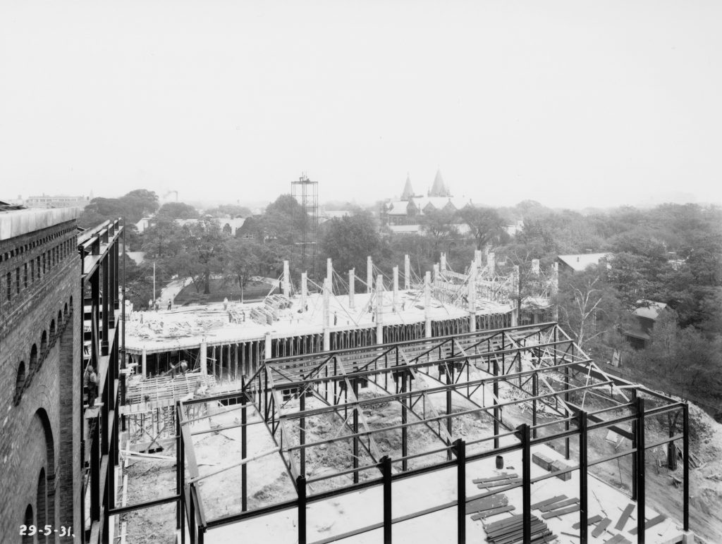 1931 - Construction of the Centre Block and East Wing of ROM, looking east with Victoria College's rooftops in the distance