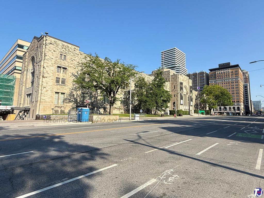 July 12, 2026 – Looking northwest along Queen's Park from Charles St W towards the Royal Ontario Museum with the Park Plaza Hotel, now the Park Hyatt Toronto, in the distance on the right